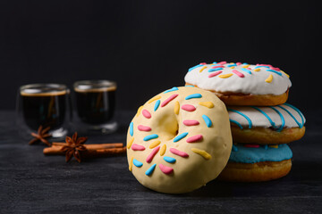 Delicious donuts on dark background, closeup