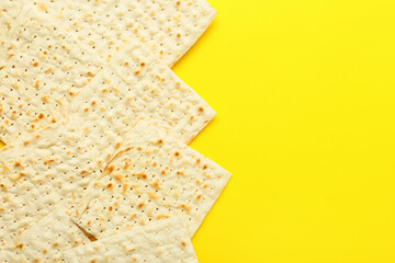 Jewish flatbread matza for Passover on yellow background
