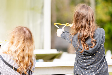 Children playing with slingshots