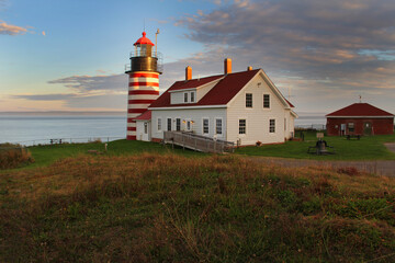 Fototapeta na wymiar West Quoddy Head Lighthouse in Lubec Maine is very colorful with it's red and white stripes.