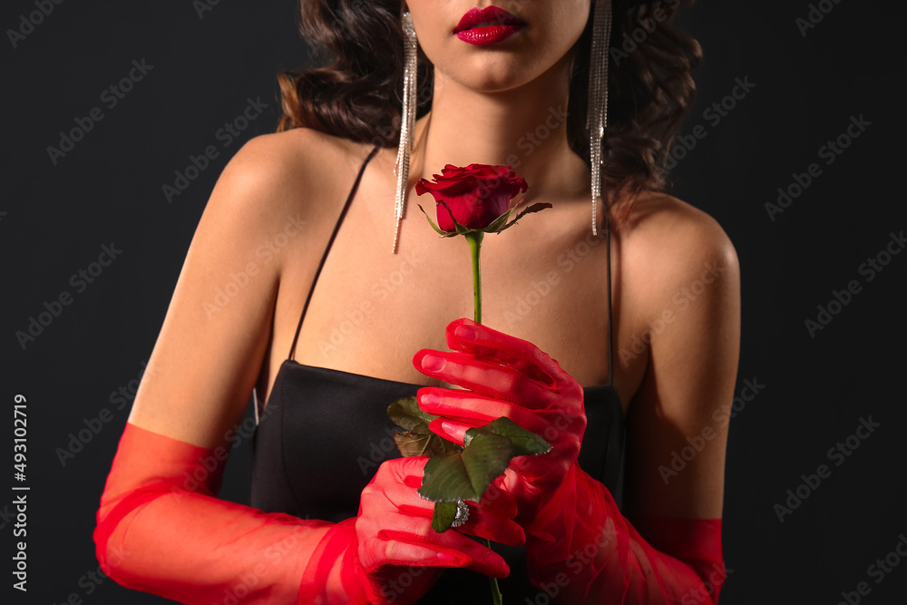 Wall mural Elegant woman wearing red gloves and stylish jewelry on dark background