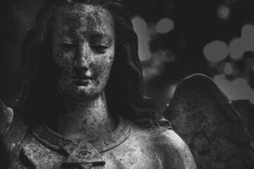 Retro styled image of an angel. Fragment of an ancient statue. Black and white image.