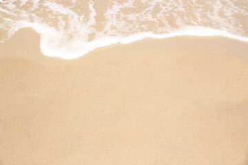 Fototapeta na wymiar beautiful texture of sandy beach, white sea foam, building sand castles, summer vacation, fun on the beach