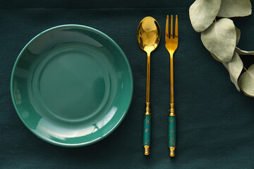 Elegant table setting on green fabric background