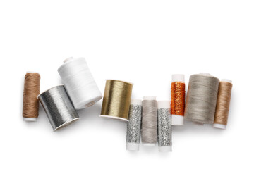Different thread spools on white background