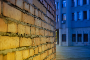 Brick wall layer. Yellow blue coloring over exterior uncovered  wall. European building industry. Rebuild Ukraine city concept after war.