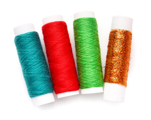 Different thread spools on white background
