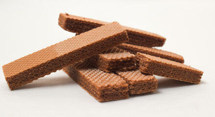 Pile of delicious chocolate wafers, on white background.