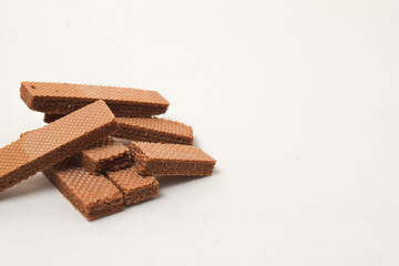 Pile of delicious chocolate wafers, on white background.