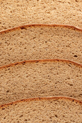 Slices of bread on a brown background. Close up.
