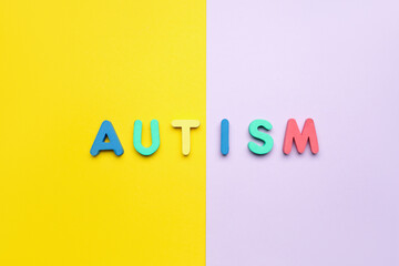 Word AUTISM on yellow and lilac background