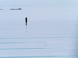 Silhoette of a person in the Salinas Grandes, a huge salt flat in the provinces of Jujuy and Salta, Argentina.