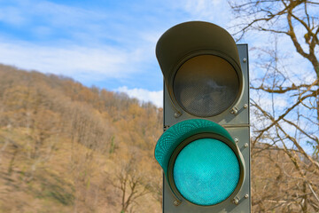 Traffic light with burning green light. Temporary traffic light during road repair.