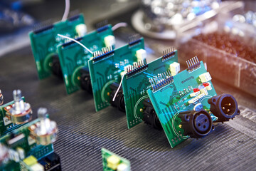 Сomputer board, circuit, chip or microchip manufacturing. Repairing Hardware Equipment. Repair Shop and Worker with Tools. Testing Modern Digital Device on Desk . Electronic Devices Concept