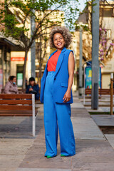 Fototapeta premium Portrait of attractive positive curly hairstyle dark skin lady smile free time outdoors
