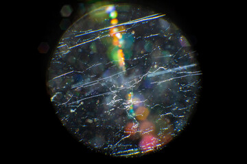 macro of dirt and fungus inside a lens, with flare