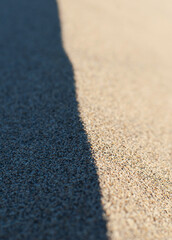 The border between light and shadow at the edge of a sand dune.