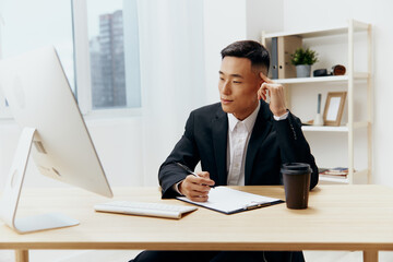 manager works at the computer glass of coffee emotion office Lifestyle