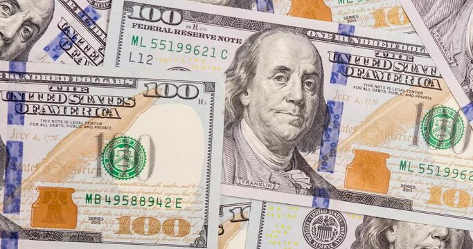 Several hundred dollars bills spread