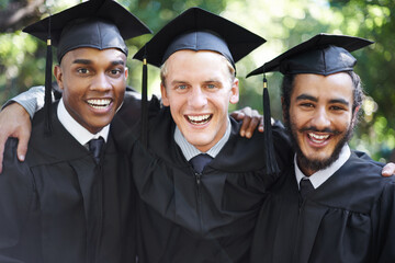 Fototapeta premium Its been tough, but weve finally made it. A group of happy male students on graduation day.