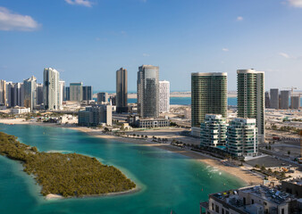 Obraz premium Aerial view of Reem Island in Abu Dhabi with mangrove trees and modern skyscrapers