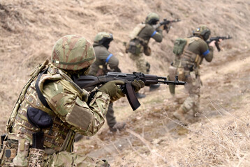 Soldiers during combat. Ukrainian soldiers with assault rifle take part in tactical exercises.