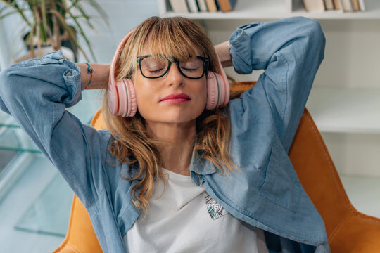relaxed woman listening to music at home