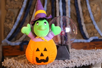 Stuffed witch inside carved pumpkin