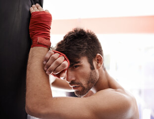 Fit and fierce. Portrait of a muscular young boxing standing in a gym.