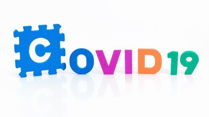 Close up on the word Covid 19 written in 3 different colors. Coronavirus pandemic and prevention...