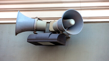 Street loudspeakers on the wall of house in the historical part of the city.