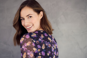 Portrait of a happy brunette caucasian woman smiling and looking beautiful standing isolated on...