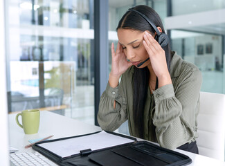 Some customers can be really difficult at times. Shot of a young call centre agent looking stressed...