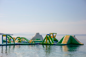 Inflatable trampoline for children on the water. Jumping city on the Croatian beach