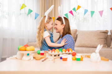 Obraz na płótnie Canvas mom and little daughter with rabbit ears celebrate Easter and and have fun 