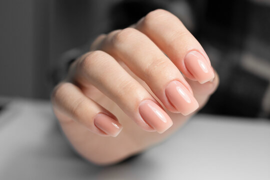 Nude manicure. Beige gel nail polish. Square shaped nails. 