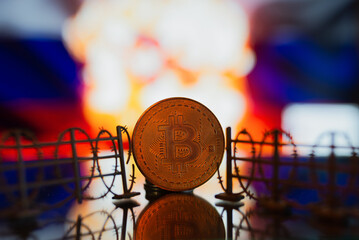 Barbed wire on the background of the Russian flag with bitcoin. The concept of sanctions and cryptocurrencies