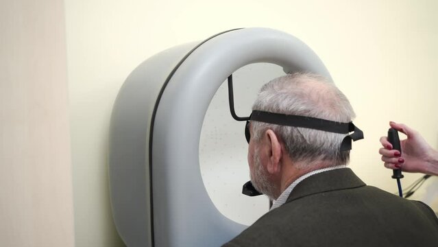 examination of elderly man on on device pnr the perimeter of the field of view