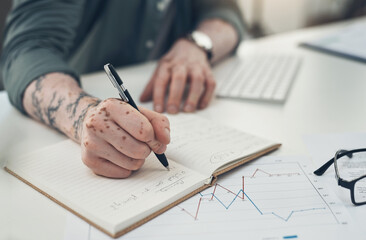 Naklejka premium Success comes to those who are busy looking for it. Sot of an unrecognizable man writing in a book at work.