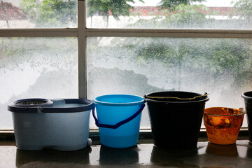 plastic bucket with wet floor in the rainy day