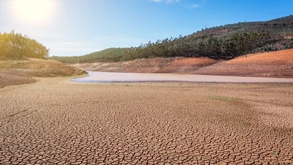  Landscape of low water and dry land in advance, severe drought in the reservoir of Portugal. Ecological disaster, soil dehydration. desert, drought, © sergojpg
