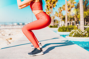 woman does gym stretching exercises outdoor in a sunny day