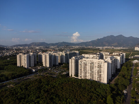 Aerial View Of Jacarépagua In Rio De Janeiro, Brazil. Residential Buildings And Mountains Around The Lake. Barra Da Tijuca Beach In The Background. Sunny Day. Drone Photo