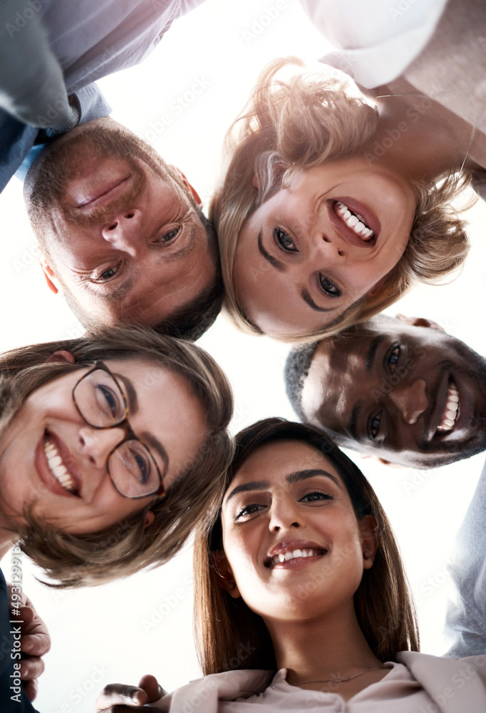 Poster we stand together and thats what makes a success. low angle portrait of a group of coworkers looking