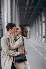 romantic date, young couple kissing on the bridge in Paris