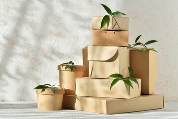 Eco packaging made of paper and cardboard. Takeaway food delivery. Various paper packages with natural light