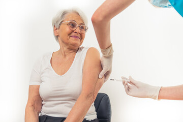 European grandmother gets the vaccine jab. White background. High quality photo