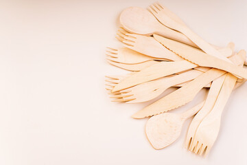 Banner eco friendly disposable kitchenware utensils on white background.Wooden forks,spoons,zero waste.Copy space.Eco friendly wooden cutlery.plastic free concept.Disposable wooden cutlery.Eco concept