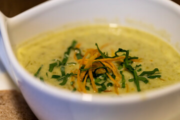 Wild garlic foam soup cream soup in white bowl for restaurant or cafe