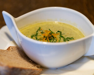 Wild garlic foam soup cream soup in white bowl for restaurant or cafe